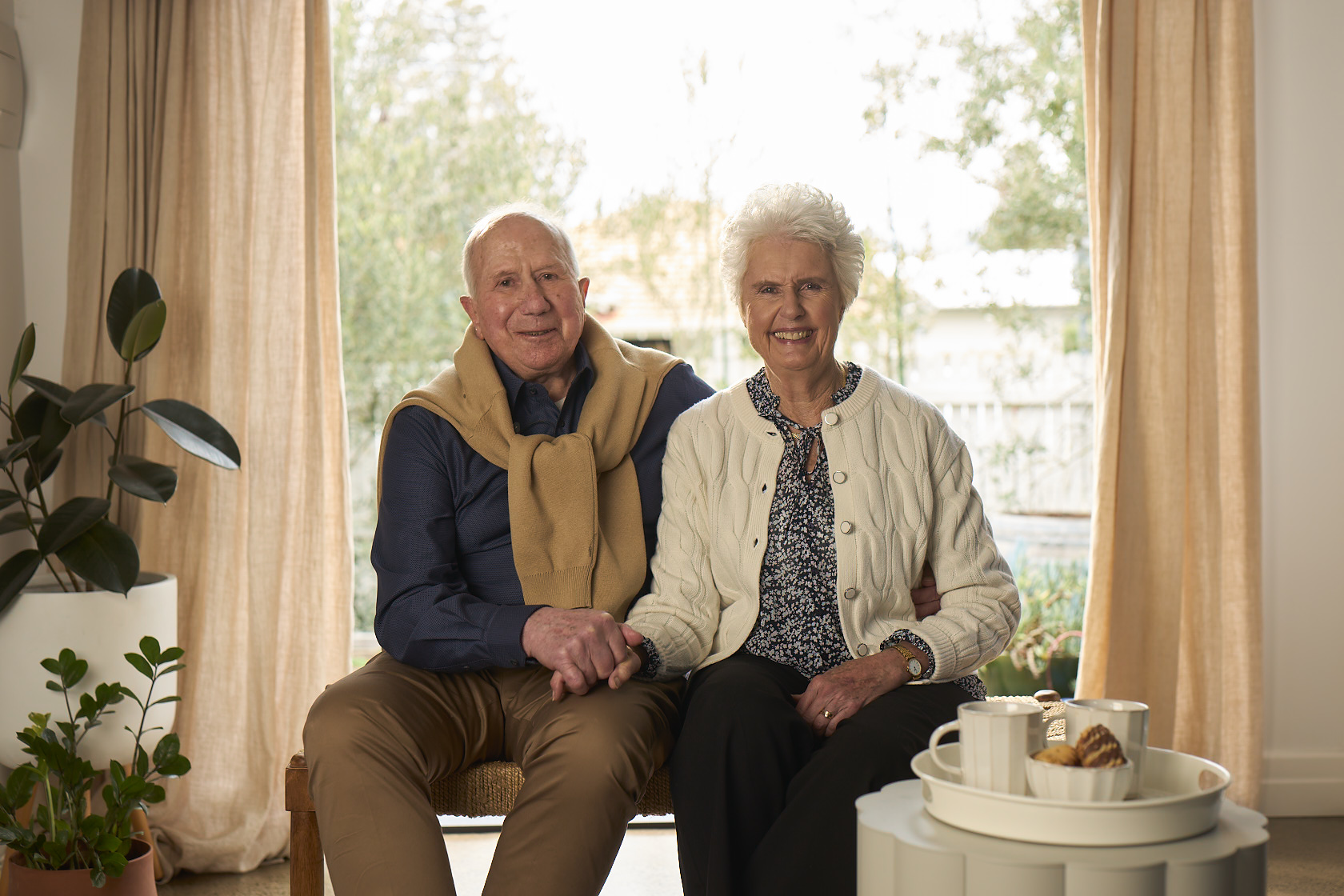Couple sitting in front of a window